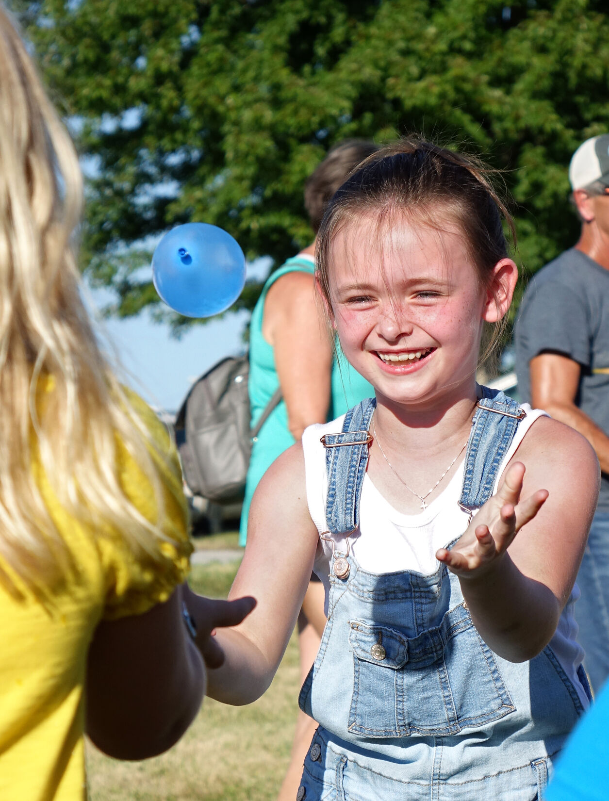 Calen Nichols, 7, catches a water balloon